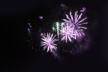 Fireworks. Salute. Sky background Amazing flash of yellow sparkling lights in the night sky during the New Year and Christmas holidays