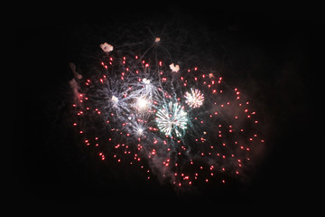 Fireworks. Salute. Sky background Amazing fountain of bright red, green and blue sparkling lights in the night sky during the New Year and Christmas holidays.