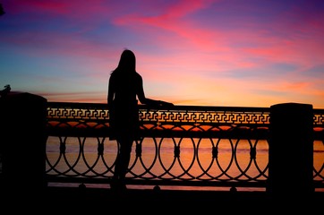 girl on the waterfront at sunset