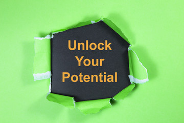 unlock your potential text on paper. Word unlock your potential on torn paper. Concept Image.