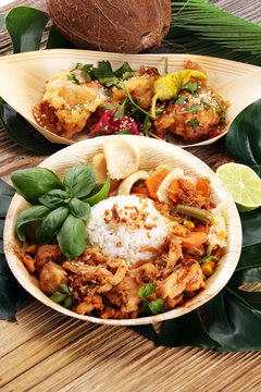various street food with chicken wings on rustic background. balinese nasi campur and indian and brasilian street food.