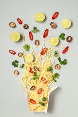 Asian food. Asian soba noodles with different ingredients in paper box, top view