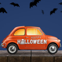 Halloween car delivering pumpkin against blue background