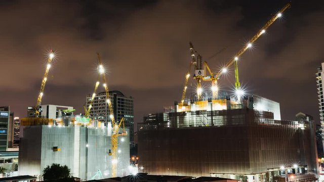 Time-lapse Of Under Construction Building Site At Night In The City Or Central Business District. Advanced Building Technology, Or Developing Industrial Country Concept