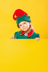 Beautiful girl child in elf costume. On a yellow background place for text, copy space.