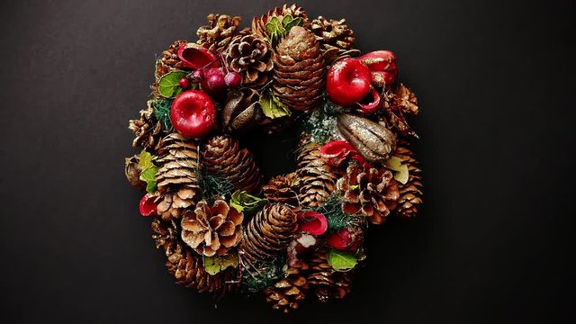 Christmas Wreath on black Background, Top View, Flat Lay, Winter Holidays Concept.