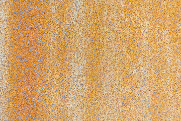 Rusty orange textured metal sheet close up