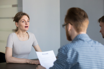 Stressed female applicant feels surprised at job interview, nervous vacancy candidate in panic confused by unexpected question shocked with result at hiring negotiation or stunned by bad impression