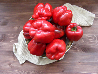 Fresh red bell pepper on wooden table.