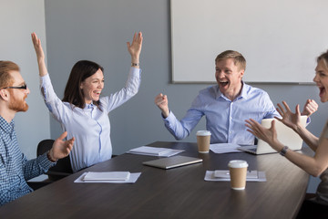 Excited motivated team coworkers celebrating unbelievable business success, good news, great work...