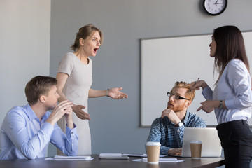 Business women colleagues disputing arguing at corporate office meeting, mad angry shocked female...