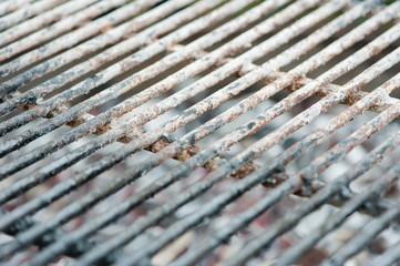 Grate for barbeque in ash close up
