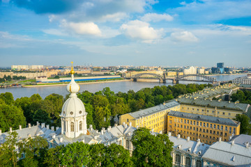 Obraz premium The view from the bell tower of the Smolny Monastery on the Neva and the Bolsheokhtinsky bridge on a summer evening in St. Petersburg. Russia