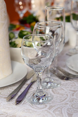 Table setting Cutlery on the person. Glasses of wine on the festive table.