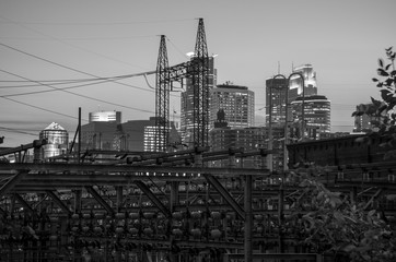 Black and White cityscape skyline of Downtown Minneapolis Minnesota in the Twin Cities Metro area. Long exposure reflection on Mississippi River, night. View from St. Anthony Main