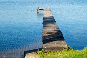 Fototapeta premium An old bridge over the lake. A place for mooring vessels.