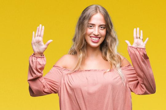 Beautiful young blonde woman over isolated background showing and pointing up with fingers number ten while smiling confident and happy.