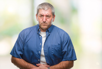 Handsome senior man over isolated background with hand on stomach because nausea, painful disease feeling unwell. Ache concept.