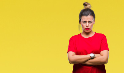 Young beautiful woman over isolated background skeptic and nervous, disapproving expression on face with crossed arms. Negative person.