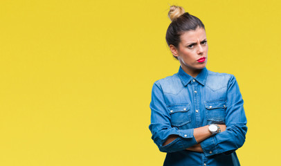 Young beautiful woman over isolated background skeptic and nervous, disapproving expression on face...