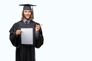 Young handsome graduate man with long hair holding blank paper over isolated background very happy pointing with hand and finger to the side