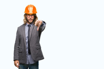 Young handsome architec man with long hair wearing safety helmet over isolated background looking unhappy and angry showing rejection and negative with thumbs down gesture. Bad expression.