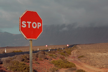 stop sign when leaving  the desert to the asphalt road