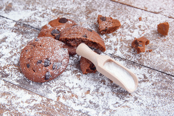 Shortbread cookies with chocolate chips on wooden background sprinkled with powdered sugar. Fresh...