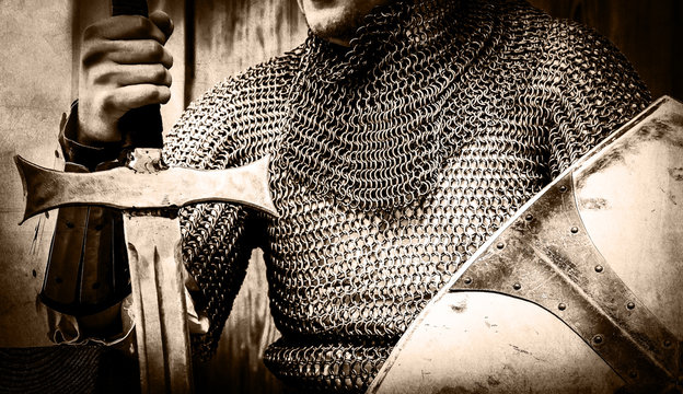 Fototapeta Knight man holding sword and shield. Image in black and white color style