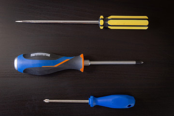 Screwdrivers on Black Wooden Background