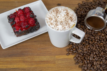 Cappuccino coffee with strawberry cheese cake and coffee beans