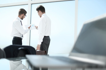 Two young businessmen shaking hands