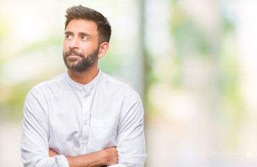 Adult hispanic man over isolated background smiling looking side and staring away thinking.