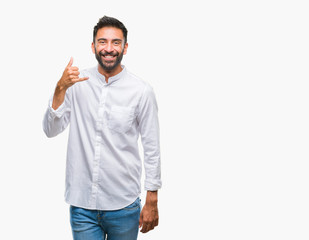 Adult hispanic man over isolated background smiling doing phone gesture with hand and fingers like talking on the telephone. Communicating concepts.