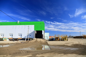 Fototapeta na wymiar The process of construction and launch of a large logistics center, its internal filling and finishing, the process of formation of the external territory and arrangement of warehouse and office space
