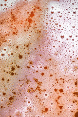 Beer foam as a background. Close up of beer bubbles