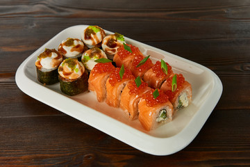 set of rolls with seafood served on a white plate