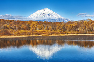 Panoramic autumn  view of the  Koryaksky Volcano reflected in the water of the lake. Russian Far East, Kamchatka Peninsula
