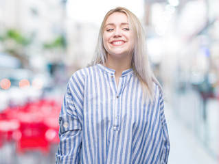 Fototapeta premium Young blonde woman over isolated background looking away to side with smile on face, natural expression. Laughing confident.