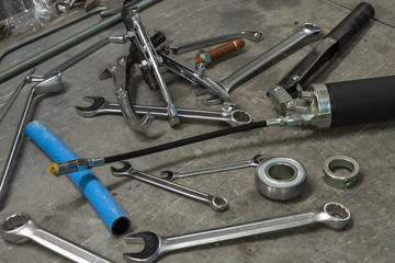 Fototapeta na wymiar Bearing puller and spanners on a mechanical engineers workbench