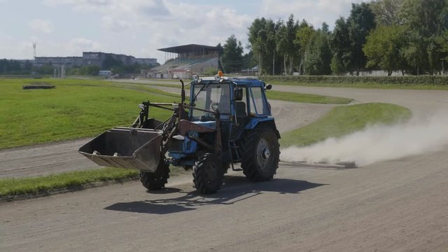 Wheeled tractor blue dub track racecourse old car tires