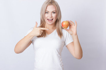Beautiful blonde woman with apple