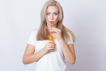 Blonde woman with orange soda in her hands