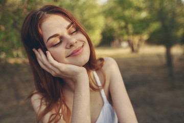 Fototapeta premium happy woman on nature with eyes closed