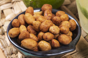Peanuts coated full in the bowl in a bar