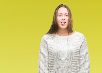 Young beautiful caucasian woman wearing winter sweater over isolated background sticking tongue out happy with funny expression. Emotion concept.