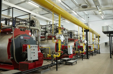 Modern new gas heating coppers work in a boiler room.