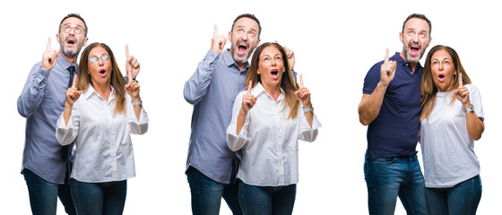 Collage of middle age mature beautiful couple of senior wife and husband over white isolated background amazed and surprised looking up and pointing with fingers and raised arms.