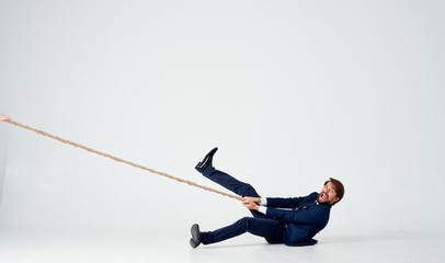 man lies on the floor and pulls the rope - Powered by Adobe