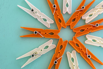 Colorful clothespins for clothes on a blue wooden background, top view. in selective focus